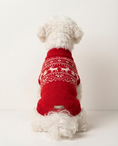 Load image into Gallery viewer, Dog wearing a red sweater with reindeer pattern on a white background